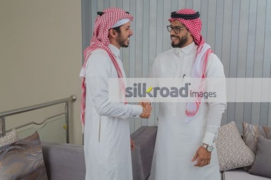 Arab Businessmen shaking hands after a meeting|